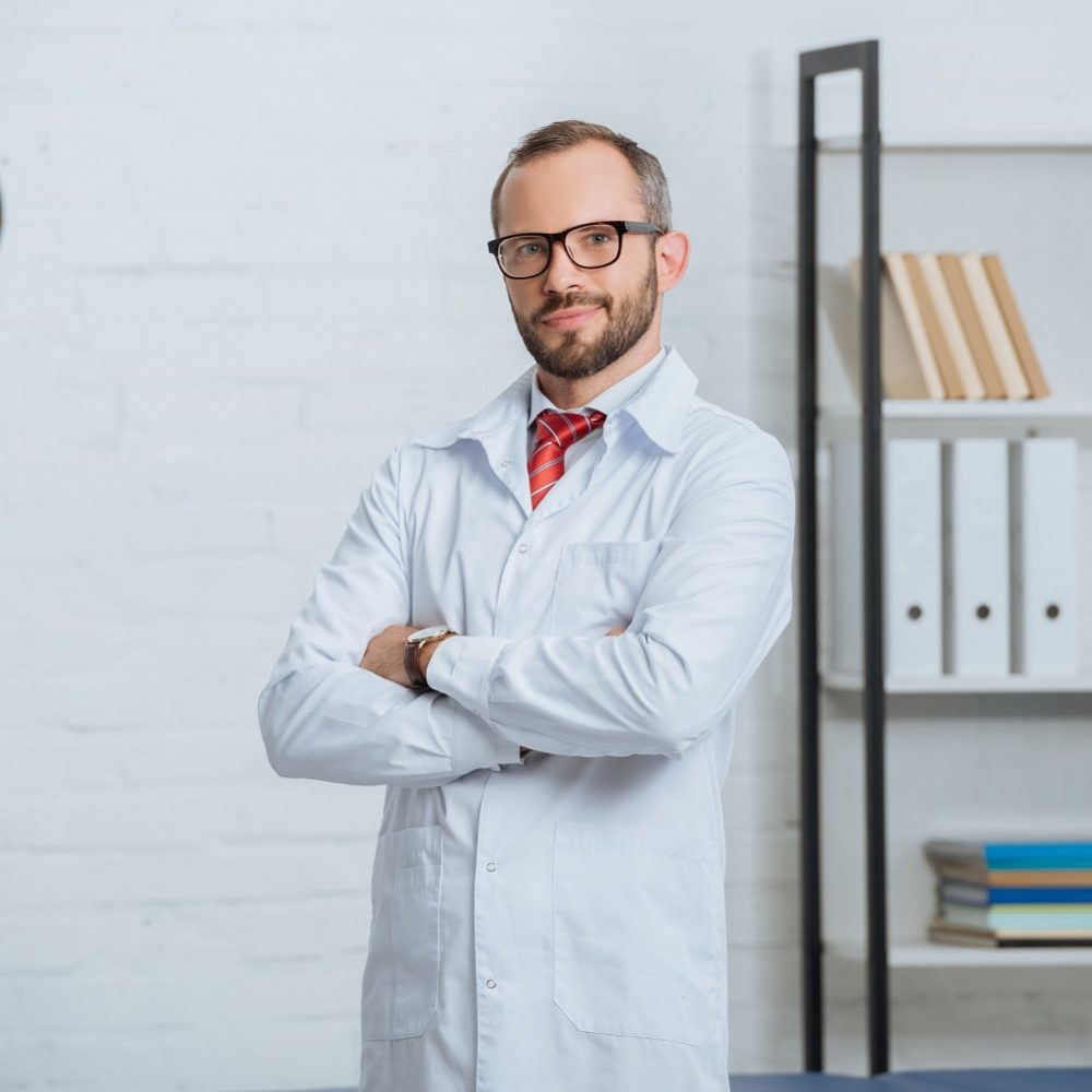 portrait-of-male-chiropractor-in-white-coat-and-ey-2022-11-02-02-22-21-utc-min.jpg